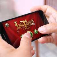 Person playing app on mobile phone
