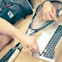 Raquetball player working on macbook pro