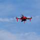 Red Drone Flying in the blue Sky