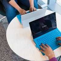 Two people working at their laptops