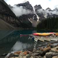 Canoes on Lake with Mountains in the scenic background in Banff National Park, Alberta, Canada