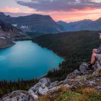 Man Sitting and overlooking the beautiful lake landscape at Banff National Park, Alberta, Canada