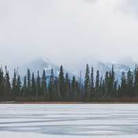 Tree Line in the horizon across the Frozen lake in Banff National Park, Alberta, Canada