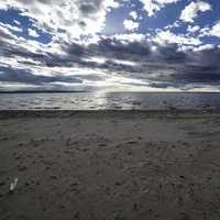 Beach and Shoreline with clouds and sky with sun