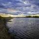 Sunset on the river under the clouds