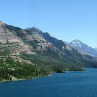 Mountains, shoreline, and lake landscape in Waterton lakes national park panorama