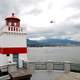 Lighthouse with plane flying in Vancouver Port in British Columbia, Canada
