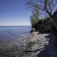 Shoreline of Lake Winnipeg with small rocks and trees