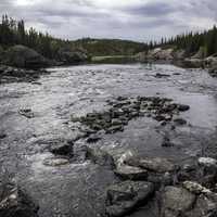 Landscape and Scenery of the Cameron River under clouds and forest