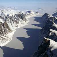 Ice covered fjord on Baffin Island with Davis Strait in the back in Nanuvut, Canada