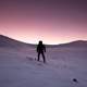 Purple Sunset in the winter of person hiking in the snow in Quebec, Canada