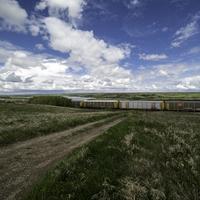 Train under the clouds and sky in Saskachewan