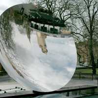 Nottingham Playhouse and Roman Catholic Cathedral reflected in Anish Kapoor's Sky Mirror in England