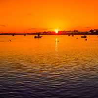 Sunset over the waters with boats at Christchurch, England