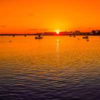 Sunset over the waters with boats at Christchurch, England