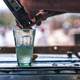 Bartender mixing a drink on a table