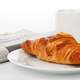 Croissant with tea and newspaper