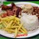 Meat, rice, beans, and fries on a platter