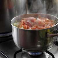 Meats cooking in a large pot