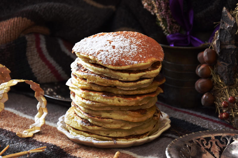 photo of a stack of pancakes with powdered sugar on top