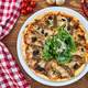 Pizza with leaves on a plate