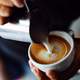 Pouring Coffee and Cream into a Cup