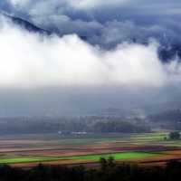 Beautiful Farm and Forest Landscape under the clouds in the French Alps