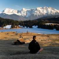 Man looking at Snow-capped Mountains landscape in Bavaria, Germany