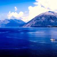 Sailboat on the ocean besides the mountains landscape shot in Greece