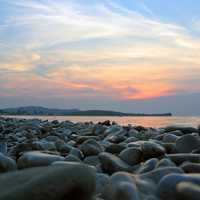 Sunset with Rocks on the seashore in Greece