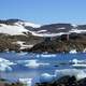 Landscape with hills and lake and ice and house in Greenland