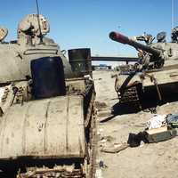 Two Iraqi tanks lie abandoned near Kuwait City in Gulf War