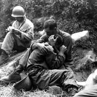 G.I. comforting a grieving infantryman in Korean War