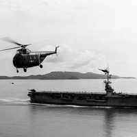 US Navy Sikorsky HO4S flying near USS Sicily during Korean War