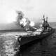 USS Missouri fires a salvo from its 16-inch guns at shore targets during Korean War