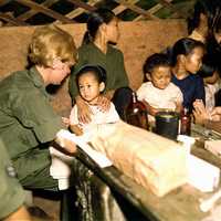 Nurse treats a Vietnamese child, 1967 during the Vietnam War