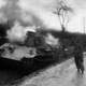 American Soldier escorting German  Crewman from burning Panther Tank during the Battle of the Bulge