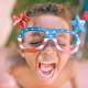 Kid Celebrating 4th of July with red white blue glasses