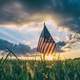 Sunset beyond the American Flag celebrating 4th of July Independence Day