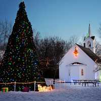 Lights and decorations and tree and church at Christmas