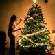 Woman decorating Ornamented Christmas Tree