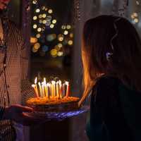 Girl Blowing out birthday Candles