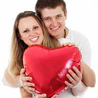 Couple holding heart balloon on Valentine's day