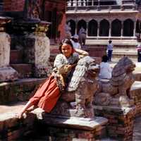 Girl Leaning on a statue in Kathmandu, Nepal