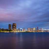 Skyline and Erasmus Bridge at night in Rotterdam, Netherlands