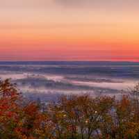 Autumn Trees and Fog over the Town at Dawn