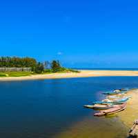 Beach with Canoe and boats with river, sea, and water