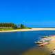 Beach with Canoe and boats with river, sea, and water