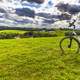 Bicycle and Background on grassy field under clouds