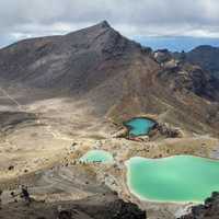 Blue ponds with mountains in the background